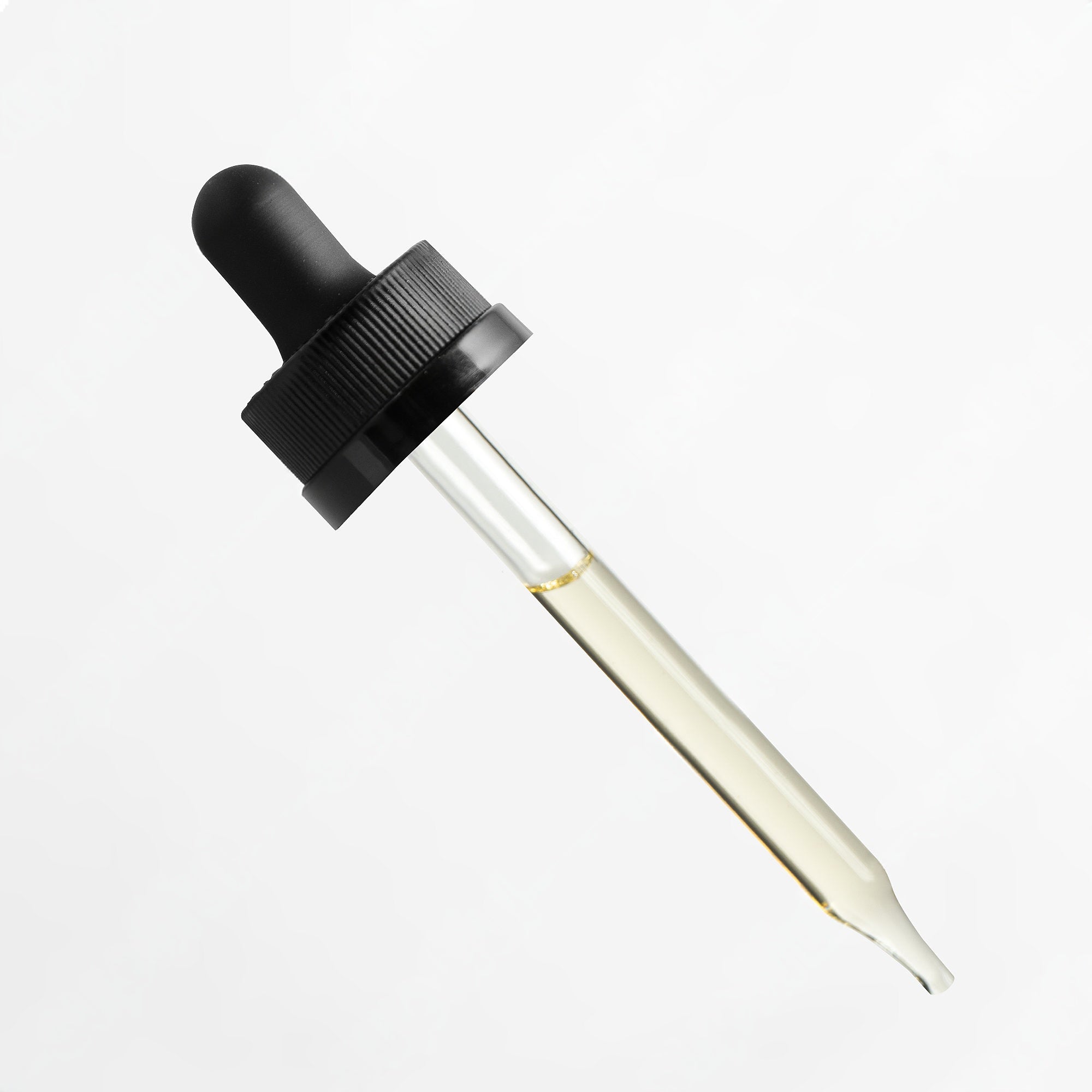 Dropper with black cap and clear glass container on a white background