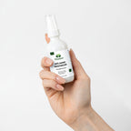 Hand holding a bottle of Vizeen anti-aging moisturizer against a white background